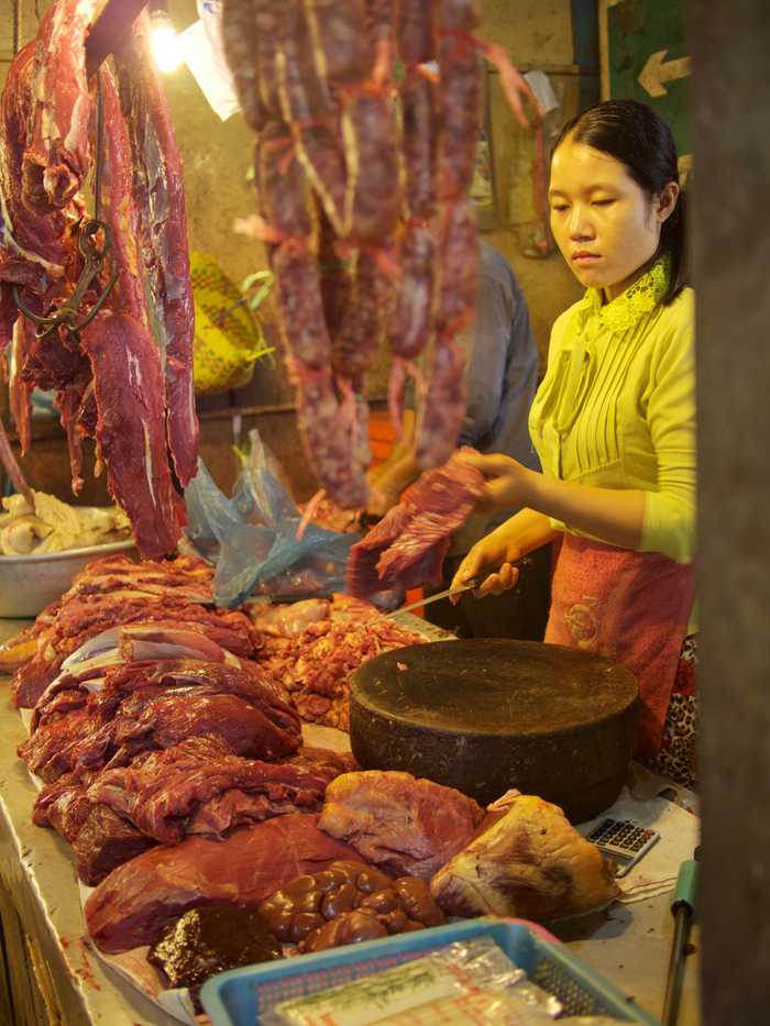 A woman selling freshly butchered meat