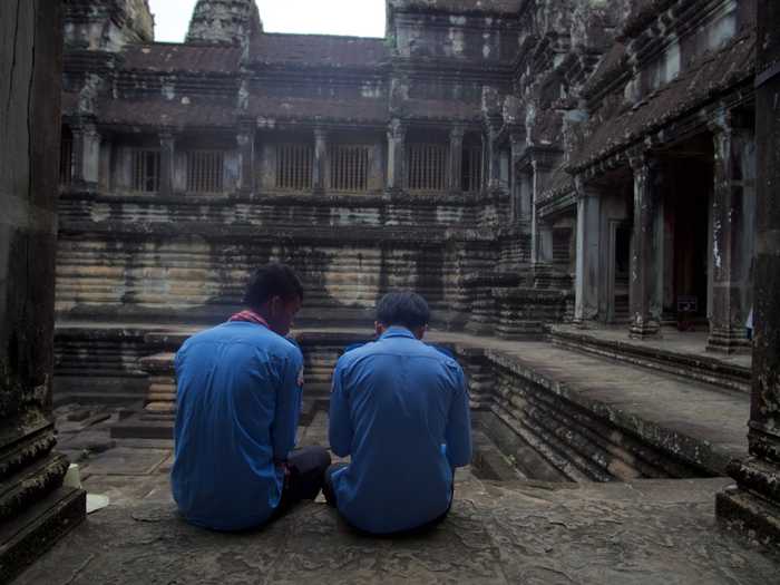 Security guards watching over ancient Angkor Wat pools