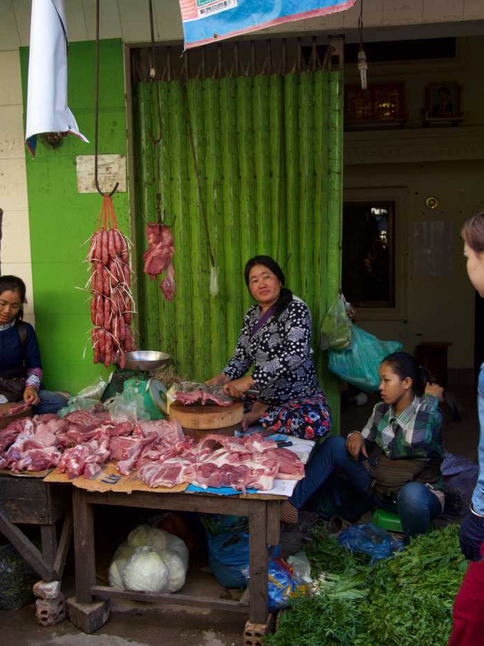 A woman butchering fresh meat on the streets